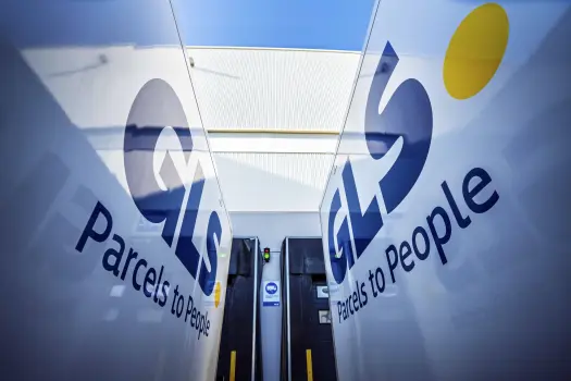 Two GLS trucks parked outside depot